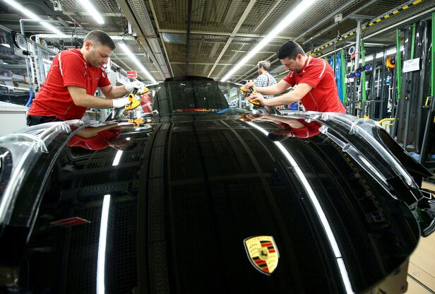 At the Porsche factory in Stuttgart-Zuffenhausen, Germany, workers install the windshield of a Porsche 911. /Courtesy of Yonhap News
